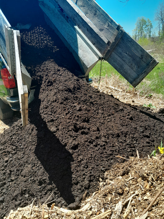 compost being dumped out of truck